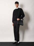 Gucci Leather GG Emblem crossbody bag with embossed GG motif - Black