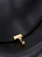 Toteme T-Lock leather crossbody bag - Black