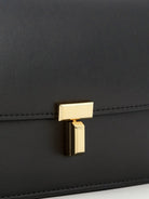 Toteme T-Lock leather crossbody bag - Black