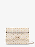 Valentino Garavani Rockstud Spike leather shoulder bag with iconic all-over studs - Lightivory